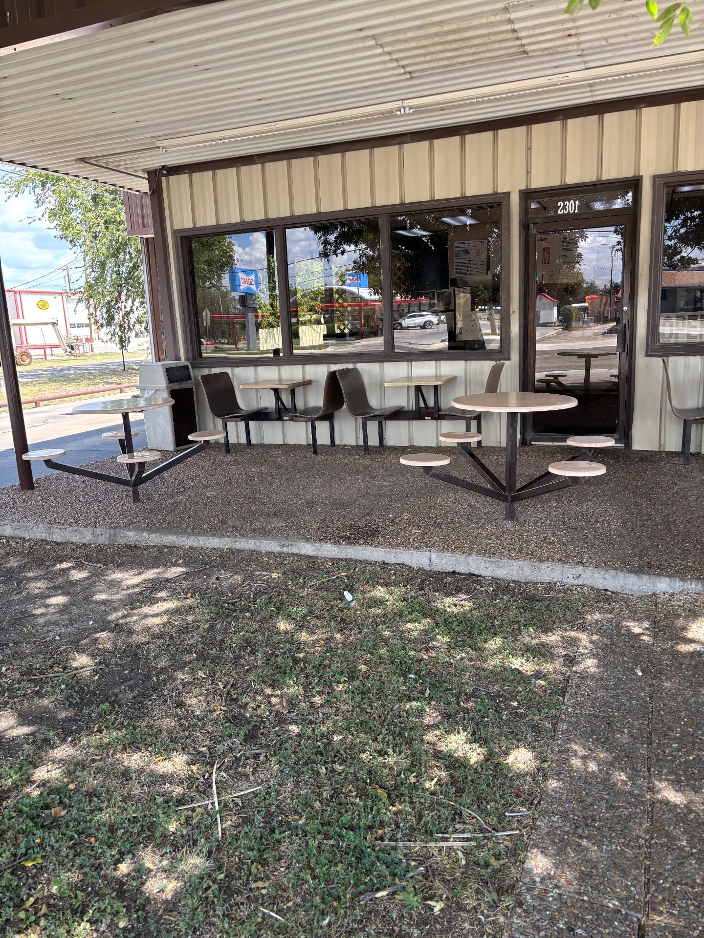 Outdoor seating beside the entrance to Best Fried Chicken